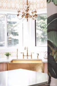 Glamorous Brass gold sink by Thompson Traders and vintage chandelier.
